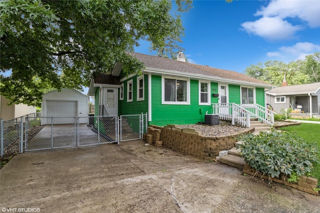 4512 Hickman Rd, Des Moines, IA 50310 - view of front of house featuring a gate, concrete driveway, a detached garage, an outdoor structure, and a chimney