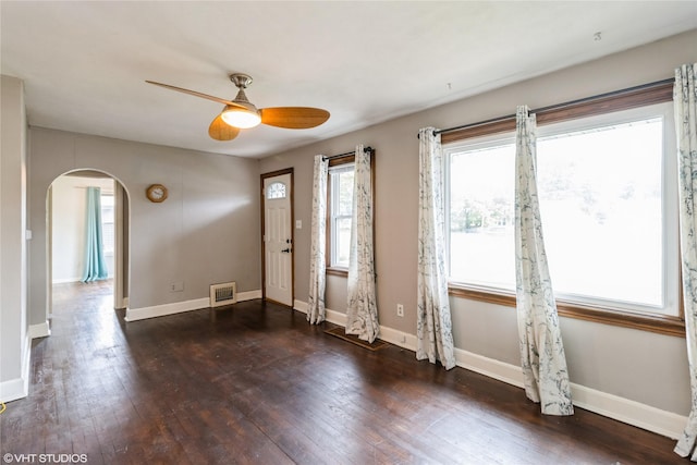 4512 Hickman Rd, Des Moines, IA 50310 - foyer featuring arched walkways, ceiling fan, and dark wood-type flooring