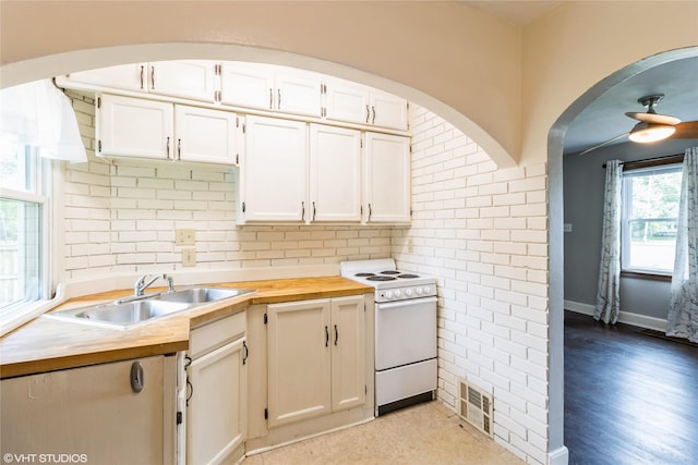 4512 Hickman Rd, Des Moines, IA 50310 - kitchen featuring electric range, tasteful backsplash, and white cabinetry