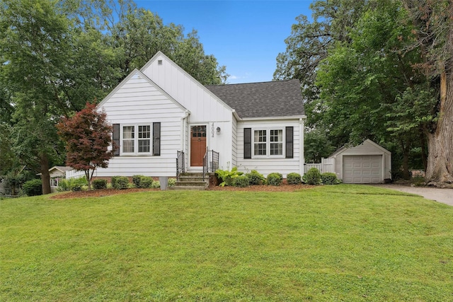 4004 Franklin Ave, Des Moines, IA 50310 - view of front of property featuring a shingled roof, an outdoor structure, a front yard, and driveway