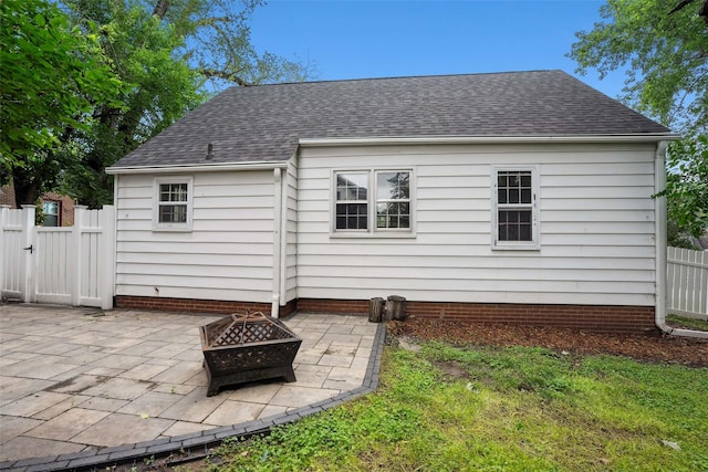 4004 Franklin Ave, Des Moines, IA 50310 - back of property featuring a fire pit, a patio, a shingled roof, and a gate