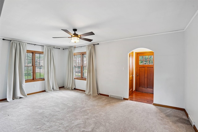 4004 Franklin Ave, Des Moines, IA 50310 - empty room with arched walkways, carpet floors, ceiling fan, and crown molding