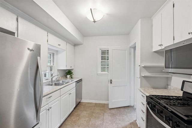 4004 Franklin Ave, Des Moines, IA 50310 - kitchen featuring appliances with stainless steel finishes, light countertops, and white cabinetry