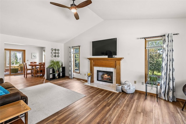 9421 NE 28th Ct, Ankeny, IA 50021 - living area featuring ceiling fan, lofted ceiling, a tiled fireplace, and wood finished floors