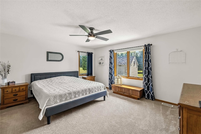 9421 NE 28th Ct, Ankeny, IA 50021 - bedroom with carpet, a textured ceiling, and a ceiling fan