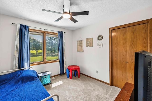 9421 NE 28th Ct, Ankeny, IA 50021 - bedroom featuring carpet floors, a textured ceiling, and a ceiling fan