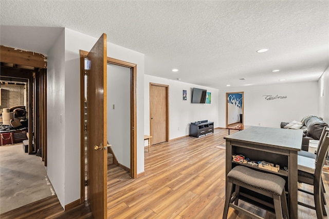 9421 NE 28th Ct, Ankeny, IA 50021 - dining room featuring a textured ceiling, light wood finished floors, and recessed lighting