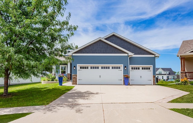 938 15th St SE, Altoona, IA 50009 - craftsman-style home featuring driveway, a garage, a front lawn, and stone siding