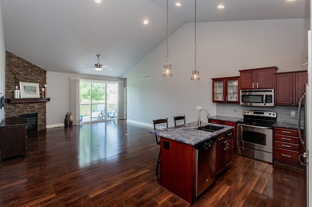 938 15th St SE, Altoona, IA 50009 - kitchen featuring stainless steel appliances, open floor plan, high vaulted ceiling, a ceiling fan, and reddish brown cabinets
