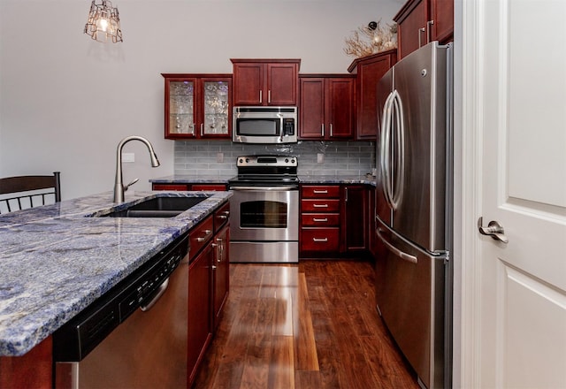 938 15th St SE, Altoona, IA 50009 - kitchen with appliances with stainless steel finishes, dark brown cabinets, dark wood-style floors, and decorative backsplash