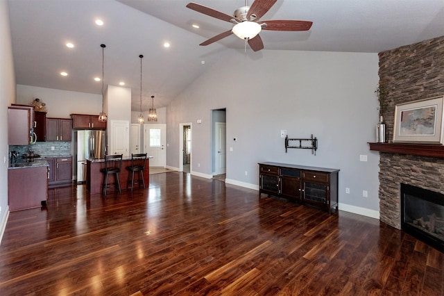 938 15th St SE, Altoona, IA 50009 - unfurnished living room with a ceiling fan, high vaulted ceiling, a fireplace, dark wood finished floors, and recessed lighting