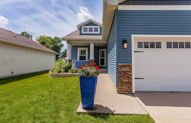 938 15th St SE, Altoona, IA 50009 - doorway to property featuring covered porch, a yard, stone siding, and roof with shingles