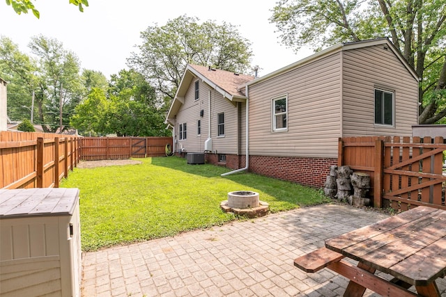 2610 Westover Blvd, Des Moines, IA 50322 - fenced backyard with a fire pit, a patio area, and a gate