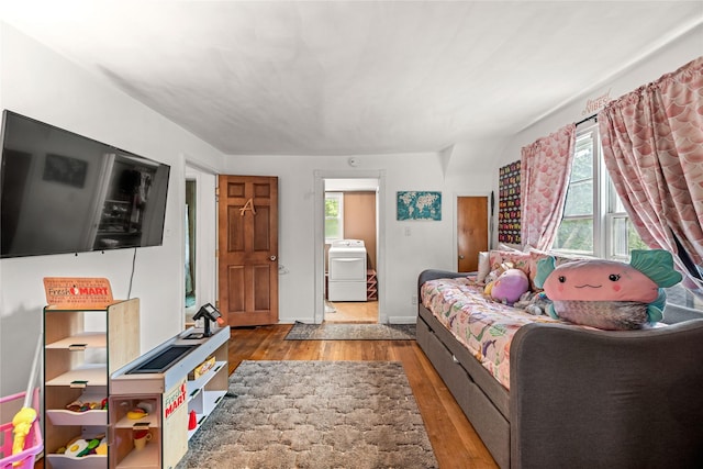 1416 Clinton Ave, Des Moines, IA 50313 - living area featuring washer / dryer, wood-type flooring, and healthy amount of natural light