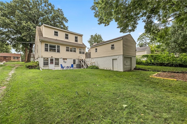 1416 Clinton Ave, Des Moines, IA 50313 - rear view of property featuring a yard, a patio area, and a shingled roof