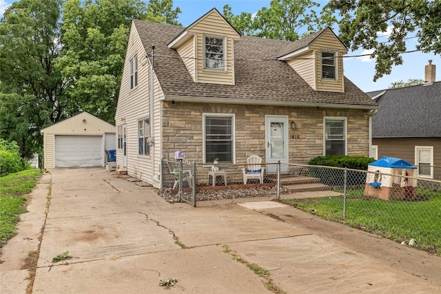 1416 Clinton Ave, Des Moines, IA 50313 - new england style home featuring stone siding, concrete driveway, an outdoor structure, and a detached garage