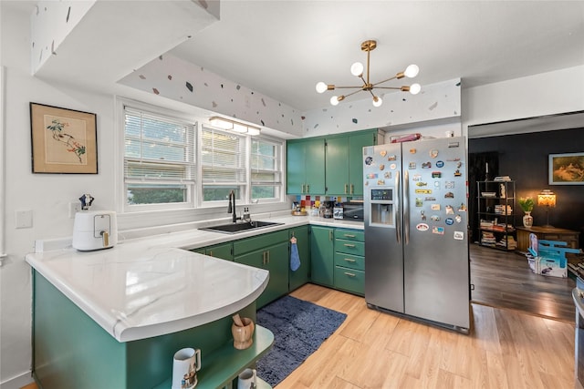 1416 Clinton Ave, Des Moines, IA 50313 - kitchen featuring stainless steel refrigerator with ice dispenser, green cabinets, light countertops, and light wood-type flooring