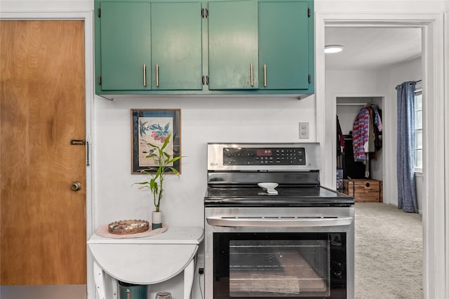 1416 Clinton Ave, Des Moines, IA 50313 - kitchen featuring electric stove, green cabinetry, light countertops, and carpet floors