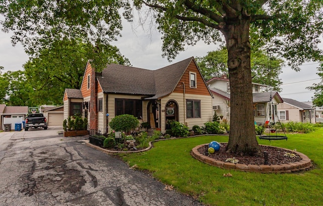 2904 48th St, Des Moines, IA 50310 - tudor home with a shingled roof and a front yard