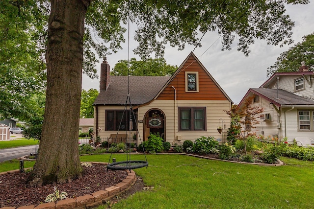 2904 48th St, Des Moines, IA 50310 - tudor-style house featuring a front yard and a chimney