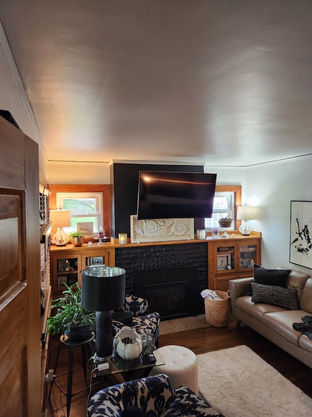 2904 48th St, Des Moines, IA 50310 - living room with wood finished floors, a brick fireplace, and plenty of natural light
