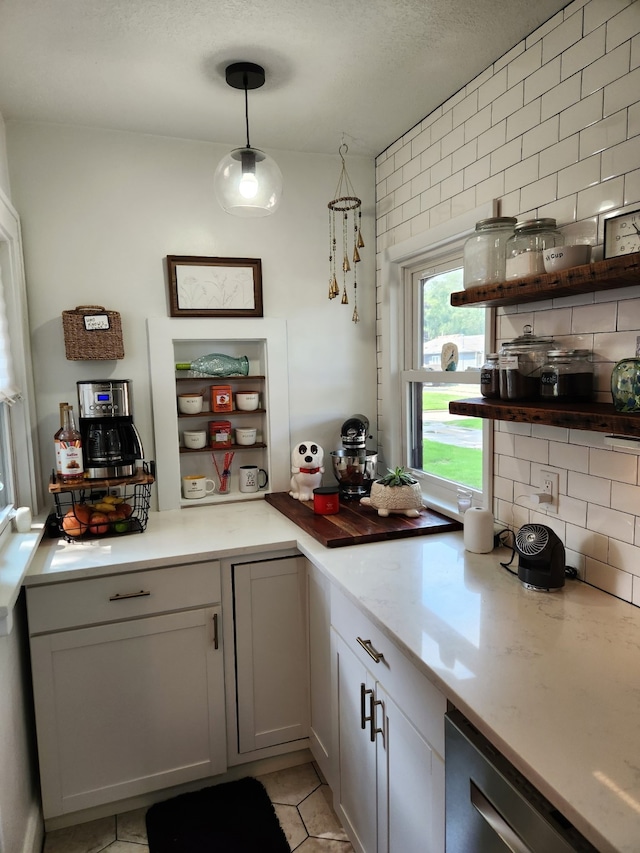 2904 48th St, Des Moines, IA 50310 - kitchen with open shelves, tasteful backsplash, dishwasher, light tile patterned floors, and decorative light fixtures