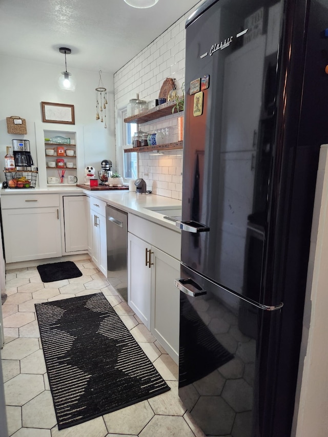 2904 48th St, Des Moines, IA 50310 - kitchen with freestanding refrigerator, stainless steel dishwasher, white cabinets, light countertops, and open shelves