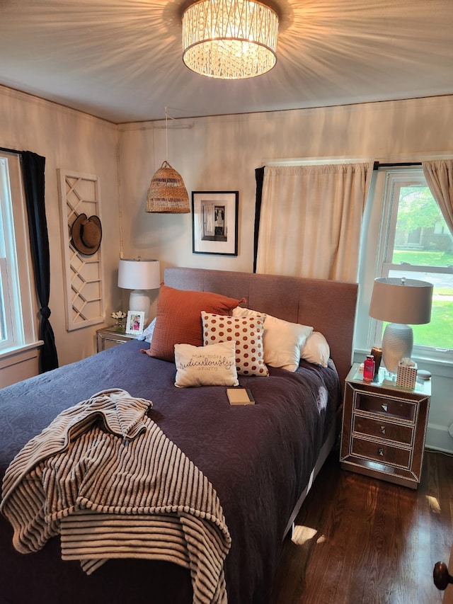 2904 48th St, Des Moines, IA 50310 - bedroom featuring wood finished floors and a chandelier