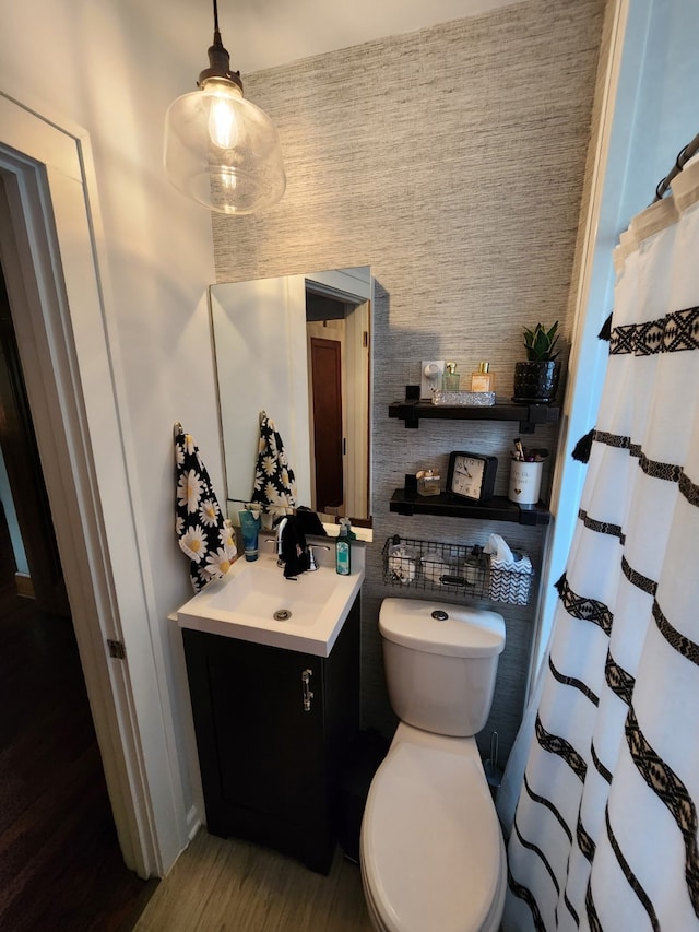 2904 48th St, Des Moines, IA 50310 - bathroom with vanity, wood finished floors, and curtained shower