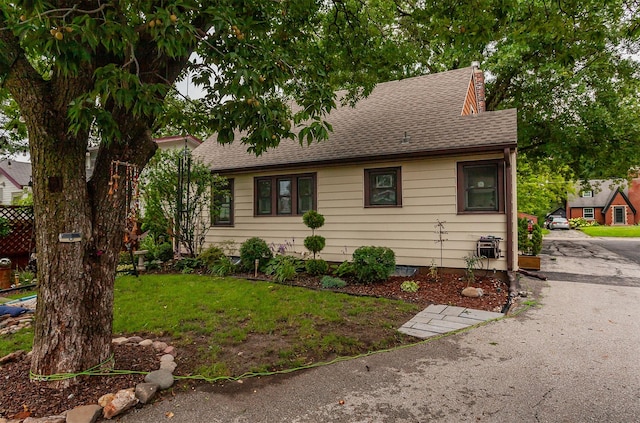 2904 48th St, Des Moines, IA 50310 - view of front of home with a chimney, a shingled roof, and a front lawn