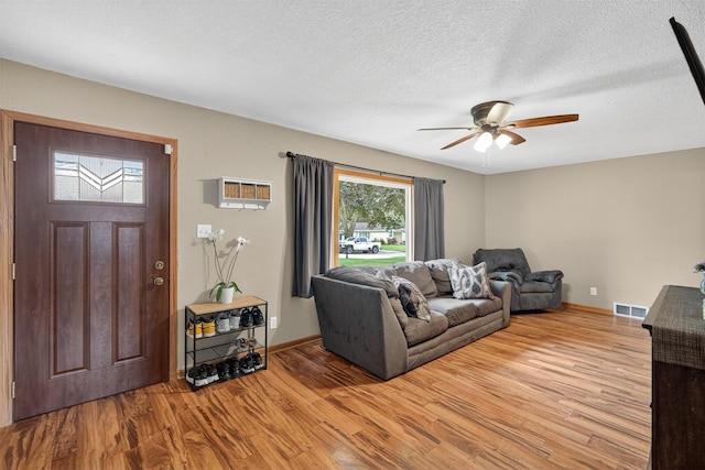 8026 Crestview Dr, Des Moines, IA 50320 - living area with a ceiling fan, wood finished floors, and a textured ceiling