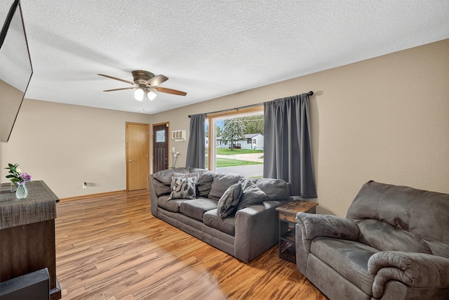 8026 Crestview Dr, Des Moines, IA 50320 - living area featuring light wood-type flooring, a ceiling fan, and a textured ceiling