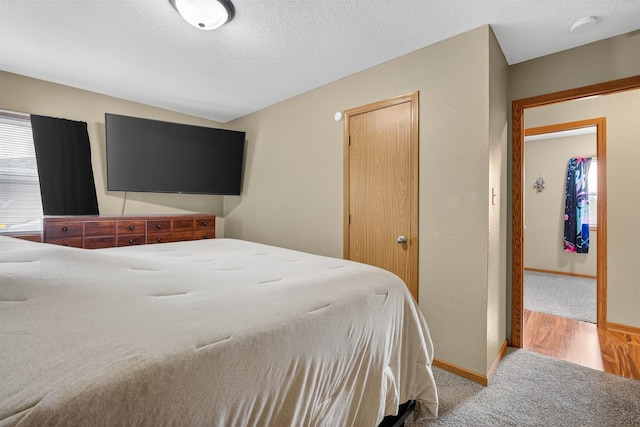 8026 Crestview Dr, Des Moines, IA 50320 - bedroom featuring carpet, a closet, and a textured ceiling