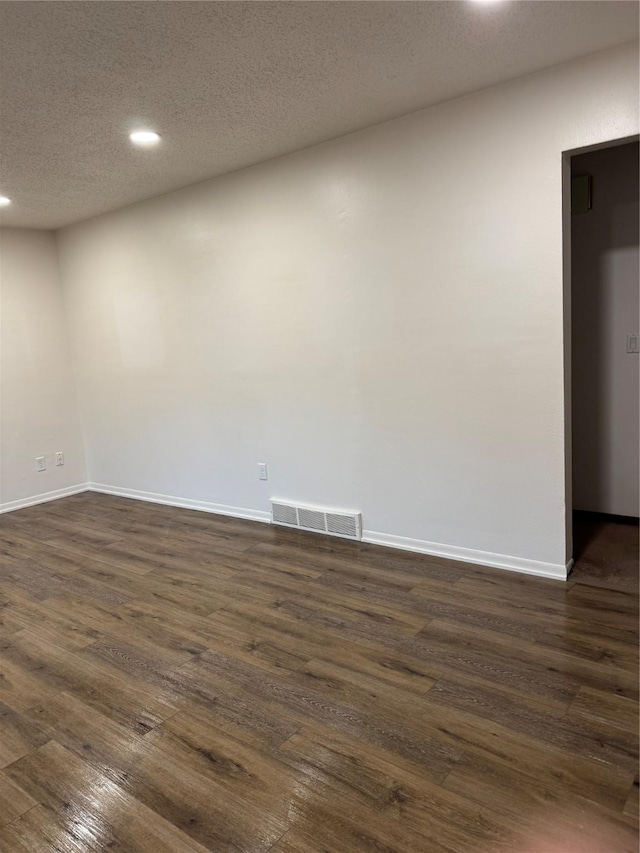 435 E Watrous Ave, Des Moines, IA 50315 - unfurnished room with recessed lighting, dark wood finished floors, and a textured ceiling