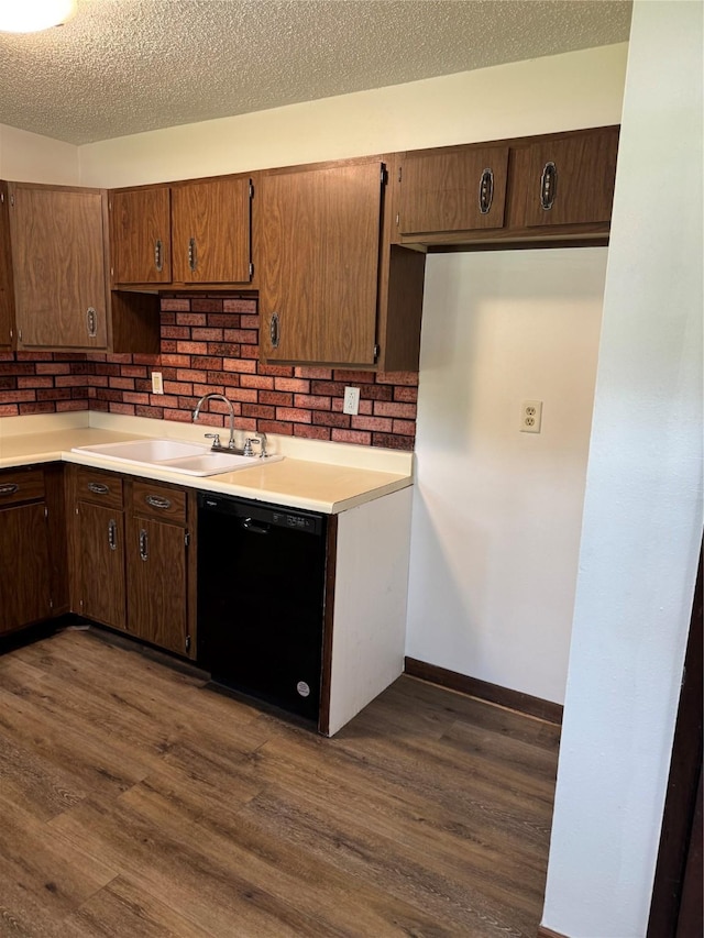 435 E Watrous Ave, Des Moines, IA 50315 - kitchen with dishwasher, dark wood-style floors, light countertops, and a textured ceiling