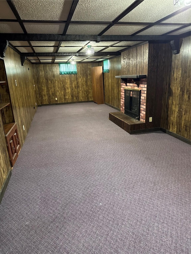 435 E Watrous Ave, Des Moines, IA 50315 - basement featuring carpet, wood walls, and a brick fireplace