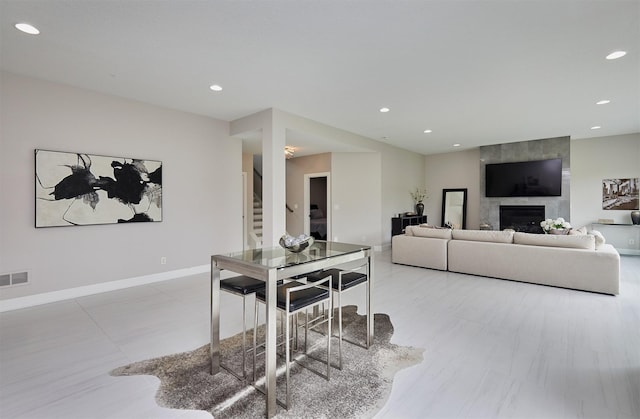 605 S Tiburon Cv, West Des Moines, IA 50266 - dining space featuring stairs, recessed lighting, and a large fireplace