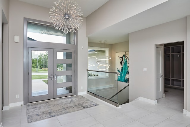 605 S Tiburon Cv, West Des Moines, IA 50266 - tiled foyer entrance with a chandelier and french doors