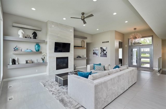 605 S Tiburon Cv, West Des Moines, IA 50266 - living area with a premium fireplace, light tile patterned floors, a ceiling fan, and recessed lighting