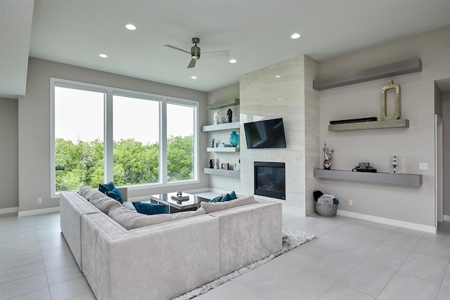 605 S Tiburon Cv, West Des Moines, IA 50266 - living room with recessed lighting, a premium fireplace, a ceiling fan, built in shelves, and tile patterned floors