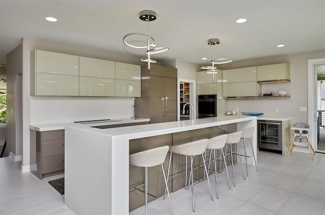 605 S Tiburon Cv, West Des Moines, IA 50266 - kitchen featuring modern cabinets, oven, light countertops, decorative light fixtures, and recessed lighting