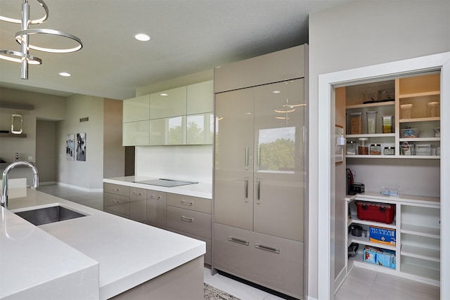 605 S Tiburon Cv, West Des Moines, IA 50266 - kitchen featuring light countertops, modern cabinets, light tile patterned flooring, recessed lighting, and black electric stovetop