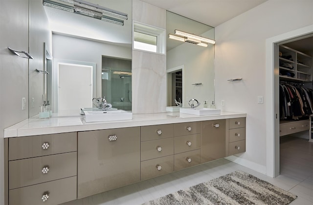 605 S Tiburon Cv, West Des Moines, IA 50266 - full bathroom with double vanity, a shower stall, a spacious closet, and tile patterned flooring