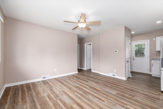 2311 Williams St, Des Moines, IA 50317 - unfurnished living room with light wood finished floors, a ceiling fan, and recessed lighting