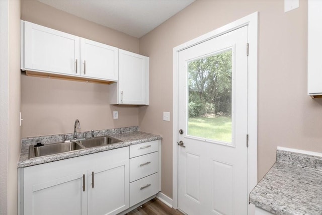 2311 Williams St, Des Moines, IA 50317 - kitchen featuring white cabinetry, light countertops, and dark wood-style floors