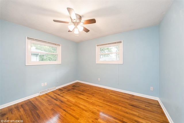 214 SW Scott St, Ankeny, IA 50023 - spare room featuring plenty of natural light, wood finished floors, and ceiling fan