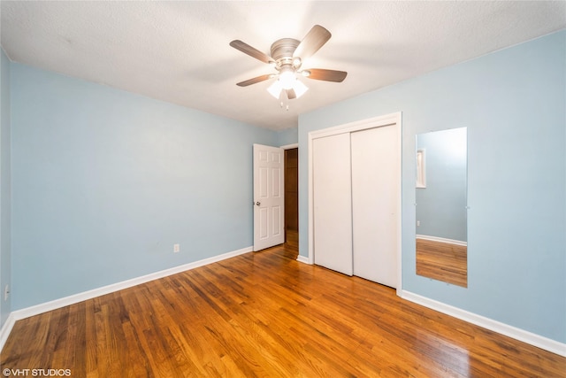 214 SW Scott St, Ankeny, IA 50023 - unfurnished bedroom with wood finished floors, a closet, and ceiling fan
