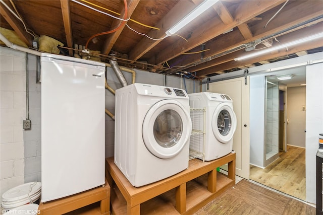 214 SW Scott St, Ankeny, IA 50023 - washroom with washing machine and clothes dryer and wood finished floors