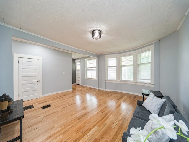 1534 9th St, Des Moines, IA 50314 - living room with ornamental molding and wood finished floors