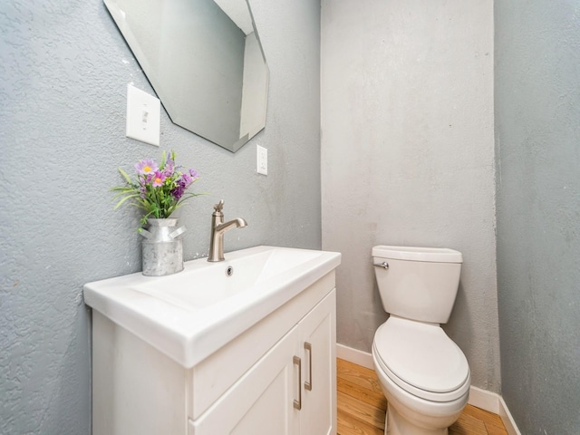 1534 9th St, Des Moines, IA 50314 - half bathroom featuring wood finished floors and vanity